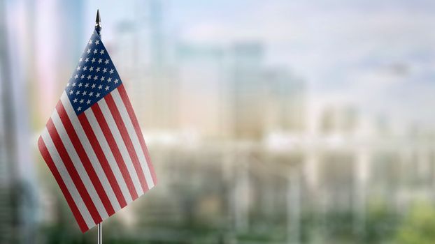Small flags of the USA on an abstract blurry background.