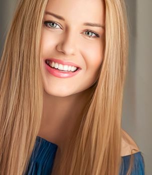 Beauty and femininity, beautiful blonde woman with long blond hair smiling, natural portrait closeup
