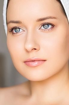 Skin care and beauty routine, beautiful woman with white towel wrapped around head, skincare cosmetics and face cosmetology, close-up portrait