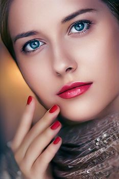 Beauty, makeup and glamour, face portrait of beautiful woman with manicure and red lipstick make-up wearing gold for luxury cosmetics, style and fashion look