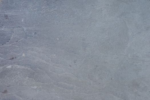 Texture of natural stone. Natural stone surface for flooring or wall decoration. Samples of gray stone with a wavy pattern for the interior.