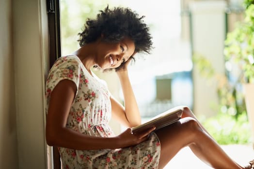 Happiest are those who read. a young woman relaxing with a book at home