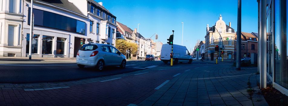 panoramic lowangle view on traffic passing a signalized junction on a sunny day