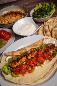 Lebanese recipe of chich taouk, garlic cream, toum, in a Lebanese bread, tabbouleh and chickpea puree, hummus High quality photo
