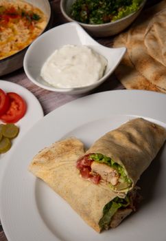 Lebanese recipe of chich taouk, garlic cream, toum, in a Lebanese bread, tabbouleh and chickpea puree, hummus High quality photo