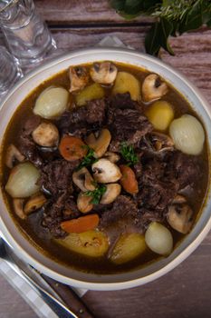 Beef bourguignon recipe, beef stew with wine sauce and vegetables. High quality photo