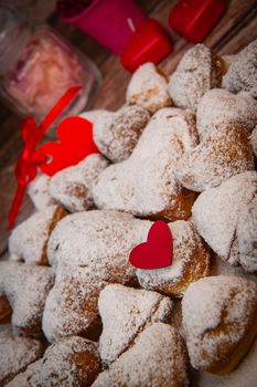 Recipe for soft heart-shaped doughnuts for Valentine's Day. High quality photo