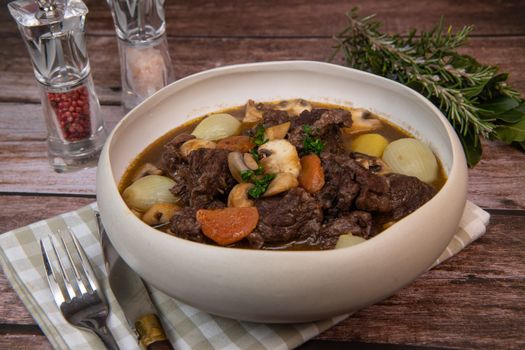 Beef bourguignon recipe, beef stew with wine sauce and vegetables. High quality photo