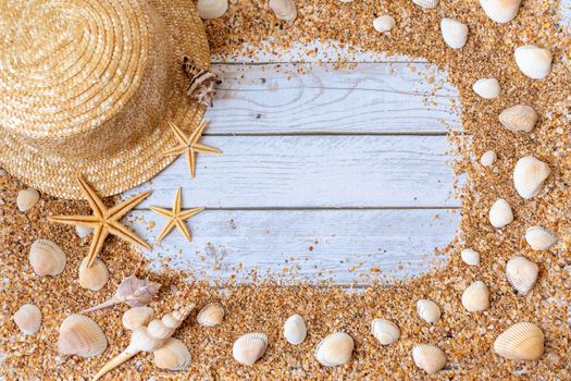 Sand seashells background. Summer time concept with sea shells and starfish on wooden background and sand.