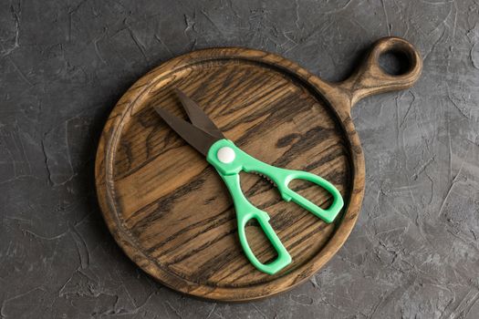 sharp kitchen scissors on a wooden cutting board in the kitchen. Close-up of kitchen accessories. cooking. Healthy eating. The cook's job.