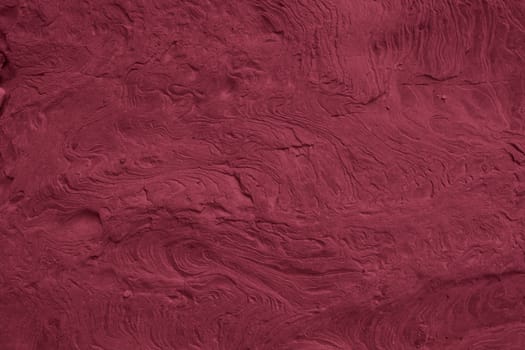 Viva Magenta toned colored grunge. Rough texture of natural stone, toned banner trendy color 2023. Grunge Viva Magenta color texture.