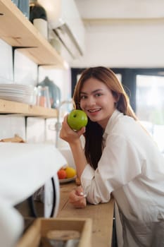 Portrait of Beautiful asian woman eating healthy food salad at kitchen room at house.