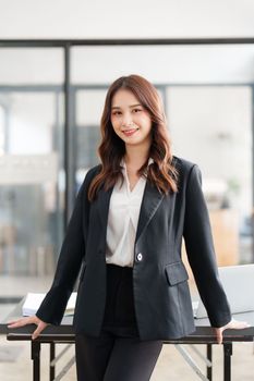 Beautiful asian business woman working at office. Financial analysis and tax concept