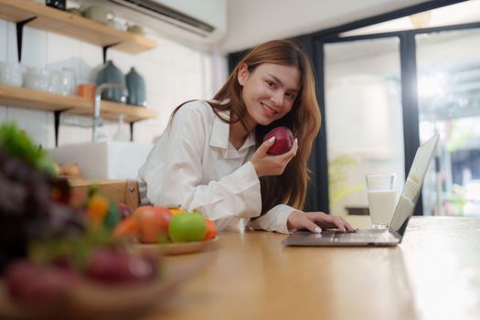 Portrait of Beautiful asian woman eating healthy food salad at kitchen room at house.