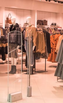 interior of fashion boutiques with modern clothing and mannequins.