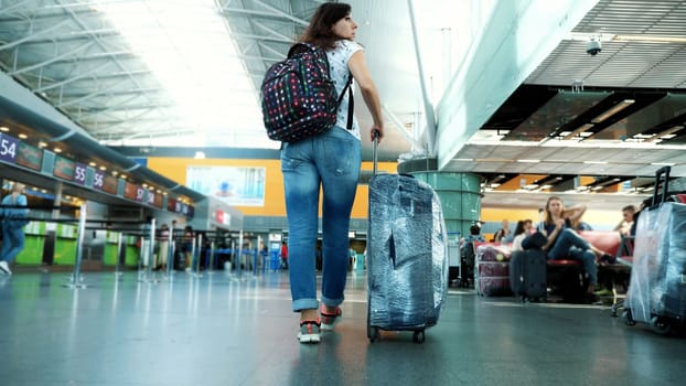 people at the airport's public check-in counter. Waiting lines in the airport and security post for passenger check in. High quality photo