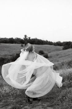 bride blonde girl and groom in a field at sunset light