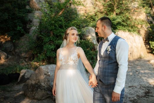 bride blonde girl and groom near the river at sunset light