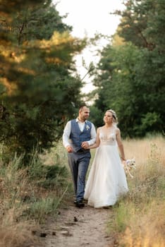 the groom and the bride are walking in the forest on a bright day