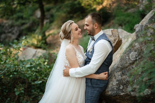 the groom and the bride are walking in the forest on a bright day