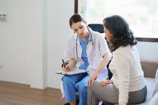 Portrait of a female doctor talking to a patient with knee pain