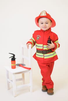 Little toddler child, playing with fire truck car toy and little chicks at home, kid and pet friends playing.