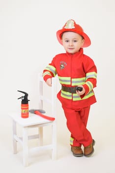 Little toddler child, playing with fire truck car toy and little chicks at home, kid and pet friends playing