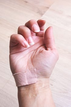 Woman's hand with adhesive plaster close up