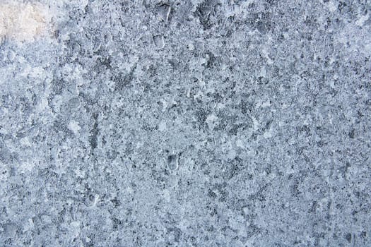 Blue frost pattern on glass closeup, background or texture