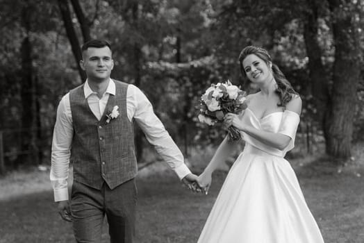 the first meeting of the bride and groom in wedding outfits in the park