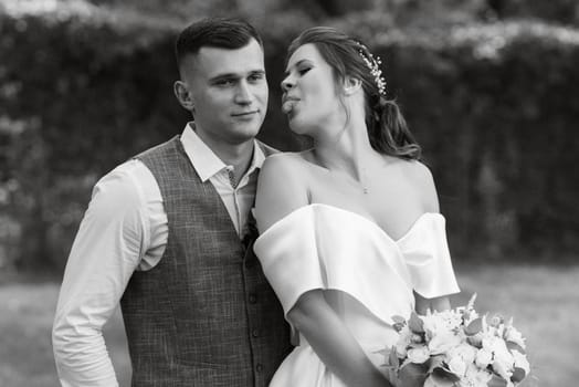 the first meeting of the bride and groom in wedding outfits in the park