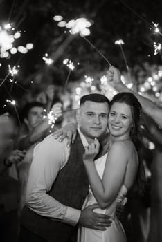 newlyweds at a wedding in the corridor of sparklers