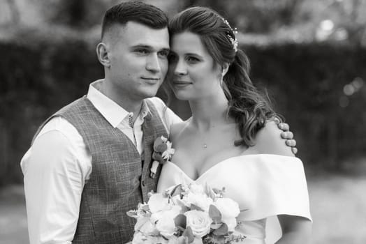 the first meeting of the bride and groom in wedding outfits in the park