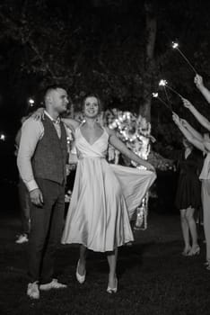 newlyweds at a wedding in the corridor of sparklers