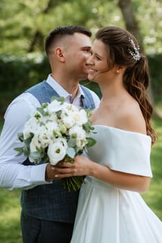 the first meeting of the bride and groom in wedding outfits in the park