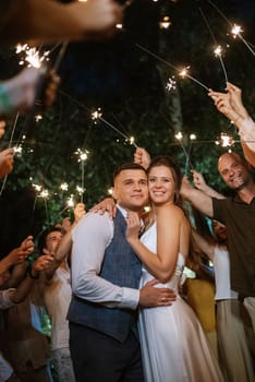 newlyweds at a wedding in the corridor of sparklers