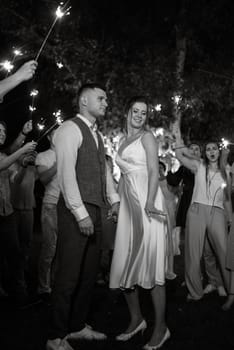 newlyweds at a wedding in the corridor of sparklers