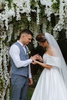 wedding ceremony of the newlyweds on the glade near the restaurant