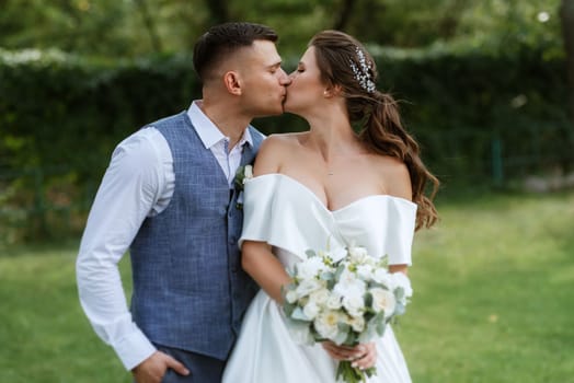 the first meeting of the bride and groom in wedding outfits in the park