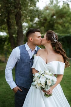 the first meeting of the bride and groom in wedding outfits in the park