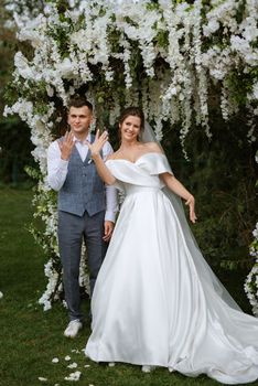 wedding ceremony of the newlyweds on the glade near the restaurant