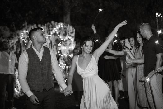 newlyweds at a wedding in the corridor of sparklers