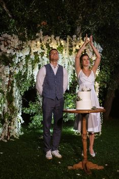 newlyweds happily cut, laugh and taste the wedding cake