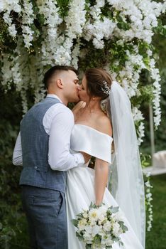 wedding ceremony of the newlyweds on the glade near the restaurant