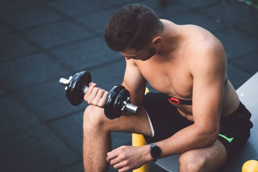 Fit man checking smart watch wearable technology sport smartwatch on workout outside. Man wearing smart watch during his training, measuring his activity. High quality photo