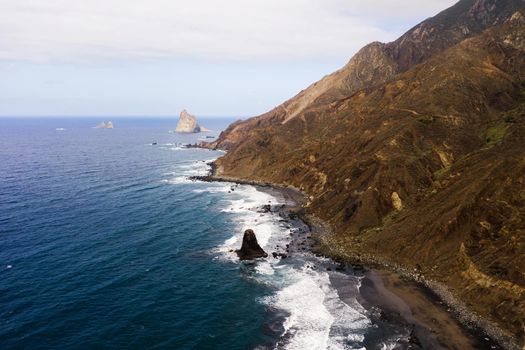 Rough rocky cliffs in the North of Tenerife. Beautiful Benijo beach in the Canary Islands. Rocks, volcanic rocks, Atlantic ocean.