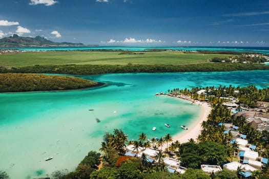 Aerial picture of the east coast of Mauritius Island. Beautiful lagoon of Mauritius Island shot from above. Boat sailing in turquoise lagoon