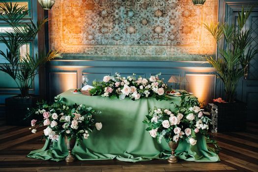 wedding table decoration with flowers on the table in the castle, table decor for dinner by candlelight.Dinner with candles.