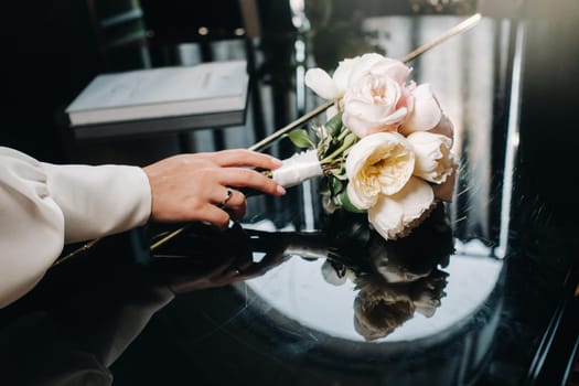 wedding bouquet with roses and boutonniere.The decor at the wedding.