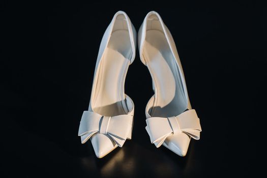 white wedding shoes on a black background.